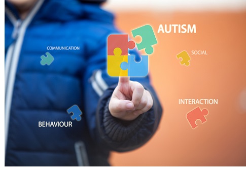 Child connecting autism awareness puzzle by pressing icons on digital virtual screen.